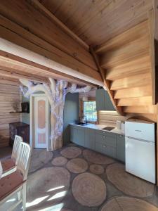 a kitchen with a tree in the middle of a room at Sodyba Atgaiva in Lazdininkai