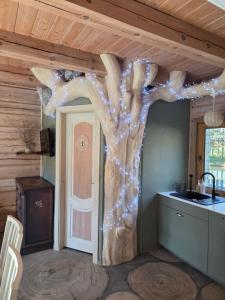 a room with a fake tree on the wall at Sodyba Atgaiva in Lazdininkai