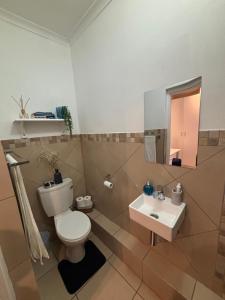 a bathroom with a toilet and a sink at Cottage in Ballito in Ballito
