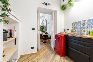 a kitchen with a red refrigerator in a room at Le Monde Luxury Apartment in Turin