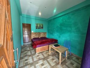 a bedroom with a bed and a table in it at Blue Heaven Tosh in Tosh