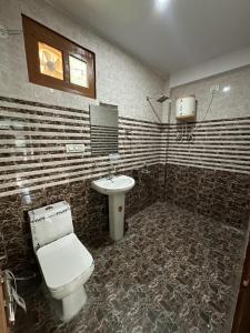 a bathroom with a toilet and a sink at Blue Heaven Tosh in Tosh +5 photos