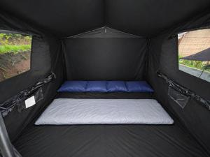 a black tent with a mattress in the middle at serlok glamping in Tangkubanperahu +18 photos