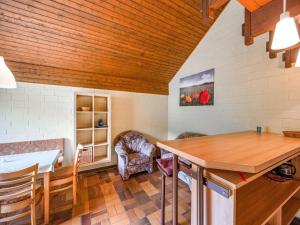 a kitchen with a table and a chair in a room at Cosy holiday home in the Hochsauerland with terrace at the edge of the forest in Schmallenberg