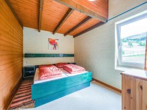 a room with a bed with pink pillows in it at Cosy holiday home in the Hochsauerland with terrace at the edge of the forest in Schmallenberg