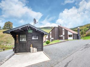 a small house on the side of a road at Cosy holiday home in the Hochsauerland with terrace at the edge of the forest in Schmallenberg