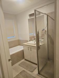 a bathroom with a shower and a sink at Cozy and comfortable room - Geelong suburbs in Grovedale