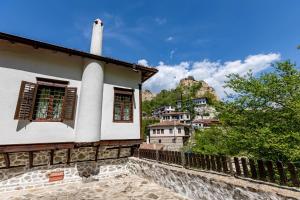 a building with a mountain in the background at Velev House in Melnik