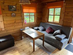 a living room with a couch and a table at Nature Getaway Holiday Home in Mujaste