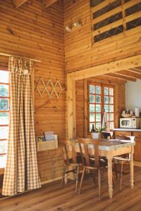 a kitchen with a table and chairs in a room at Le Chalet du Michel in Hardifort