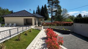 a house with a garden with red flowers at Villa Aida in Sarajevo