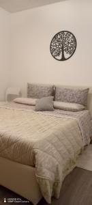 a bedroom with a bed with a tree on the wall at S1 Home Sila in Camigliatello Silano