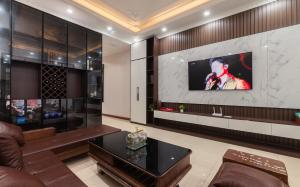 a living room with a tv on a wall at Willow Stay in Hai Phong