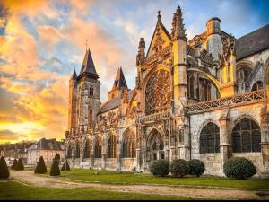 an old cathedral with a sunset in the background at Cosy travels in Les Andelys