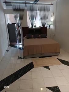a bedroom with a bed on a tiled floor at Studio near Trou aux Biches beach, Chantilla Vie in Trou aux Biches +33 photos