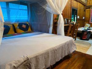 a bedroom with a bed with a canopy at Ha Giang Uphill Coffee Farmstay in Ha Giang