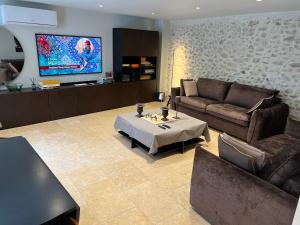 a living room with a couch and a table at DURANCE in La Brillanne