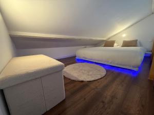 a room with two beds with blue lights in it at suite Jacuzzi terrasse privé parking in Caligny +6 photos