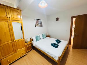 a bedroom with a bed with blue pillows on it at Apartment Nencheva in Sandanski