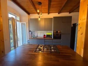 a kitchen with a stove top in a room at Casa Claudia Pieve centro storico in Tremosine Sul Garda