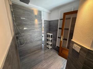 a bathroom with a shower and a glass door at Casa Claudia Pieve centro storico in Tremosine Sul Garda +50 photos