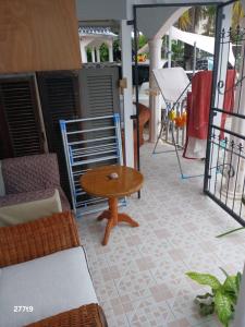 a room with a table and chairs on a patio at Studio near Trou aux Biches beach, Chantilla Vie in Trou aux Biches