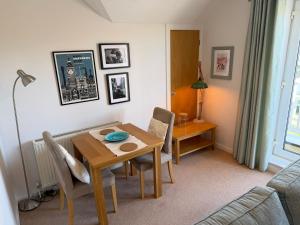 a living room with a dining room table and a table and chairs at Ballard Down View, Swanage 2 Bed in Swanage