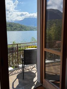 a view of a lake from a balcony at Albergo Mezzolago in Calceranica al Lago