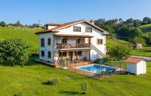 a large house with a swimming pool in a field at Posada Adela in Santillana del Mar
