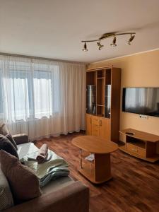 a living room with a couch and a table at Teatra 34-31 in Daugavpils