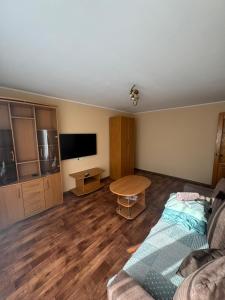 a living room with a couch and a table at Teatra 34-31 in Daugavpils