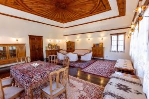 a large living room with a table and chairs at Velev House in Melnik