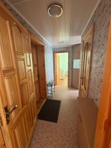 a hallway of a room with a door and a room with a chair at Teatra 34-31 in Daugavpils