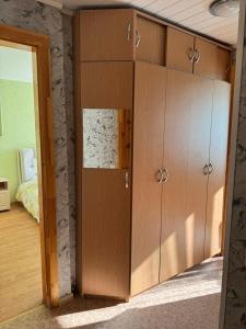 a large wooden cabinet in a room at Teatra 34-31 in Daugavpils +1 photo