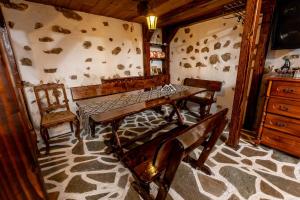 a dining room with a wooden table and chairs at Velev House in Melnik