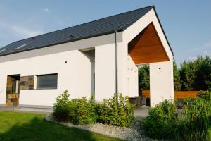 a white house with a black roof at Willa Gostomko in Gostomko