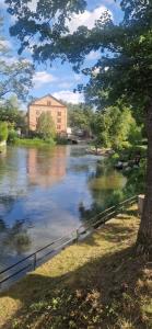 a view of a river with a building in the background at Central City Apartment A in Nyköping +4 photos