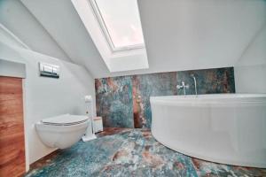 a bathroom with a toilet and a sink and a tub at Willa Gostomko in Gostomko +16 photos