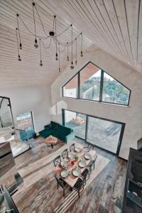 a room with a table and chairs and a large window at Willa Gostomko in Gostomko
