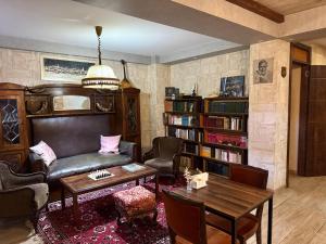 a living room with a leather couch and a table at Hotel "Tbilisi Tales" in the heart of the Old City in Tbilisi City +124 photos