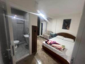 a bedroom with a bed and a bathroom with a shower at Airport See Viem See Apartment in Arnavutköy +25 photos