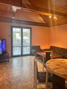 a living room with a table and a tv at Dombi-Lak in Tiszakécske