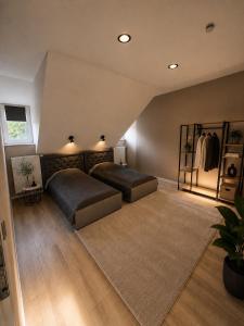 a large bedroom with two beds and a rug at Whitewill by Gerda in Groß Bartensleben