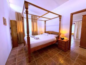 a bedroom with a four poster bed and a mirror at Tropicalidays Oceanview Chayofa in Chayofa +29 photos