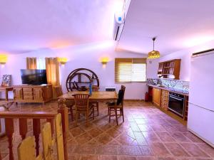 a kitchen and dining room with a table and chairs at Tropicalidays Oceanview Chayofa in Chayofa