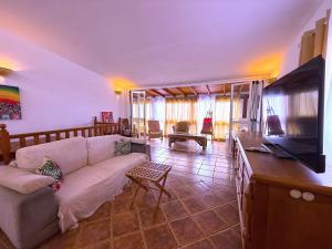a living room with a couch and a flat screen tv at Tropicalidays Oceanview Chayofa in Chayofa
