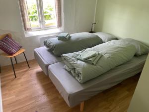 two pillows on a bed in a room with a window at Ner-Grefstad gard in Kallstad