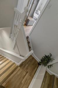 an open stairwell with white walls and wooden floors at Riverside Crossing in Worcester
