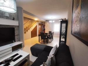 a living room with a couch and a table at Adosado kintsuji in Sanlúcar de Barrameda +20 photos