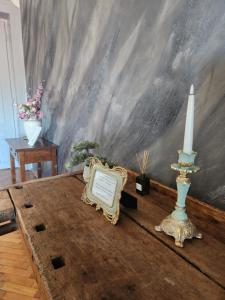 a room with a table with a candle and a plaque at Central old town escape in Timişoara +53 photos